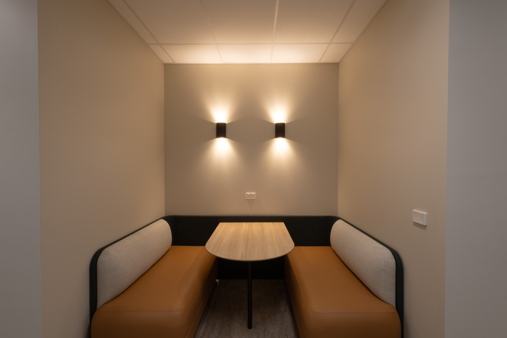 A breakout space in an office, with a suspended Pinnacle ceiling and couches.